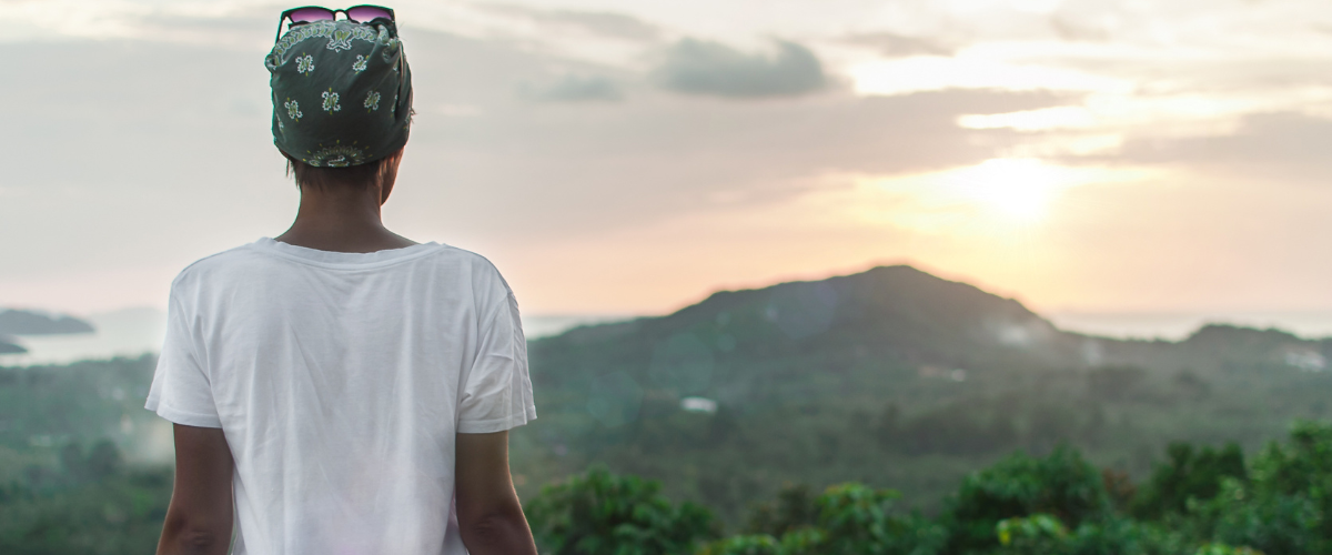 Woman embracing sunlight in nature, symbolizing self-loyalty, energy healing, and personal empowerment at Solara Academy.