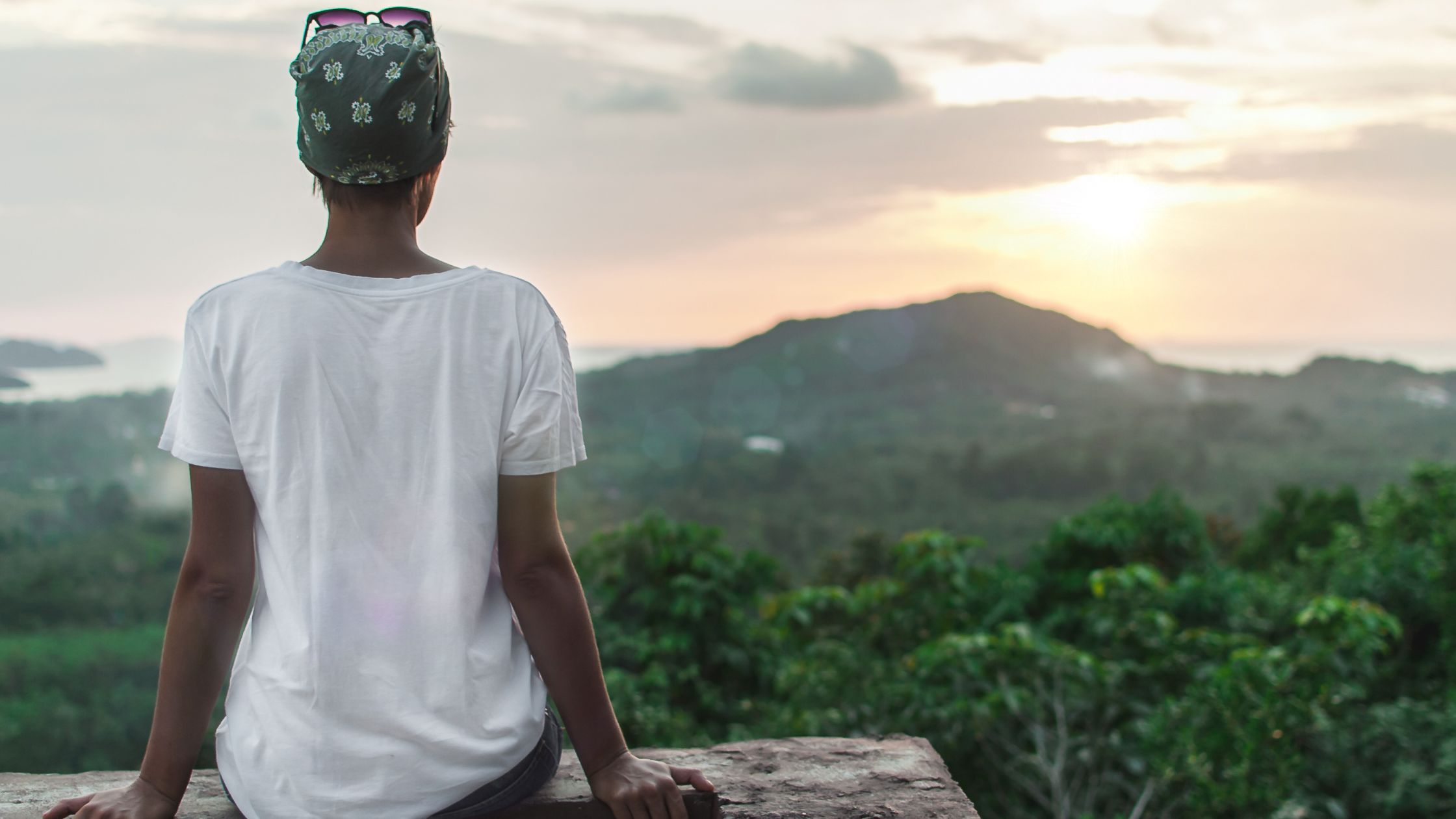 Person gazing at sunset in nature, symbolizing self-reflection and healing, promoting Solara Academy’s blog on self-loyalty and transformation.