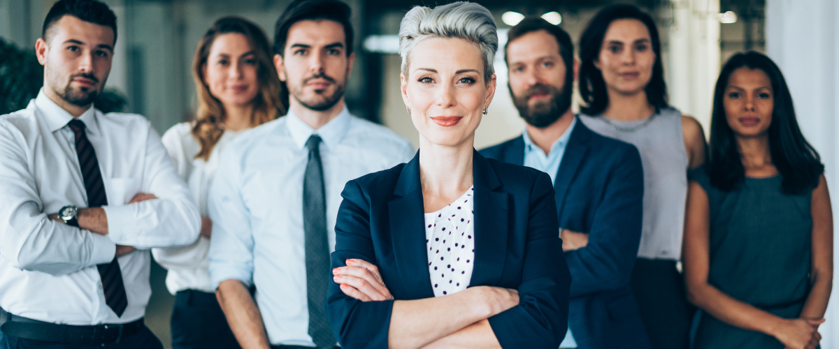 Group of diverse professionals standing together smiling confidently, representing the Intuitive type as a natural leader and decision maker