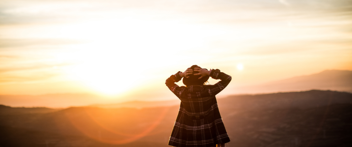 Woman standing alone at sunset reflecting on inner knowing and big picture awareness associated with the Prophetic gift
