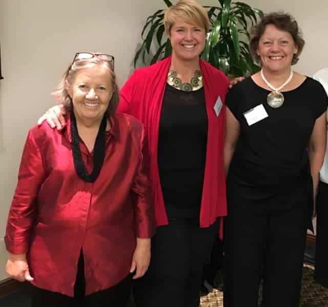 A photo of Kristy Kaye and 2 other women on her team at an event sharing the wisdom of her spiritual growth books